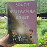 South Australian Coast journal held up against garden sink hole