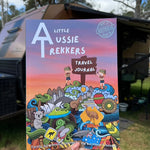 A colorful travel journal titled 'Kids Australian Travel Journal' being held in front of a camping backdrop.