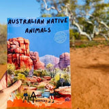 Australian Native animal book being held up in desert background