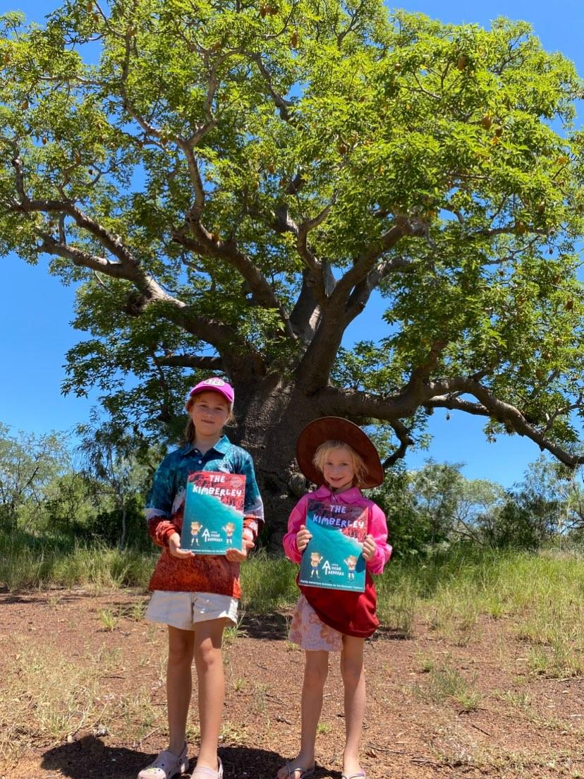 two kids holding a australian kids journal titled the kimberley
