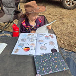 Australian travel journal working on  outdoors with a vehicle in the background