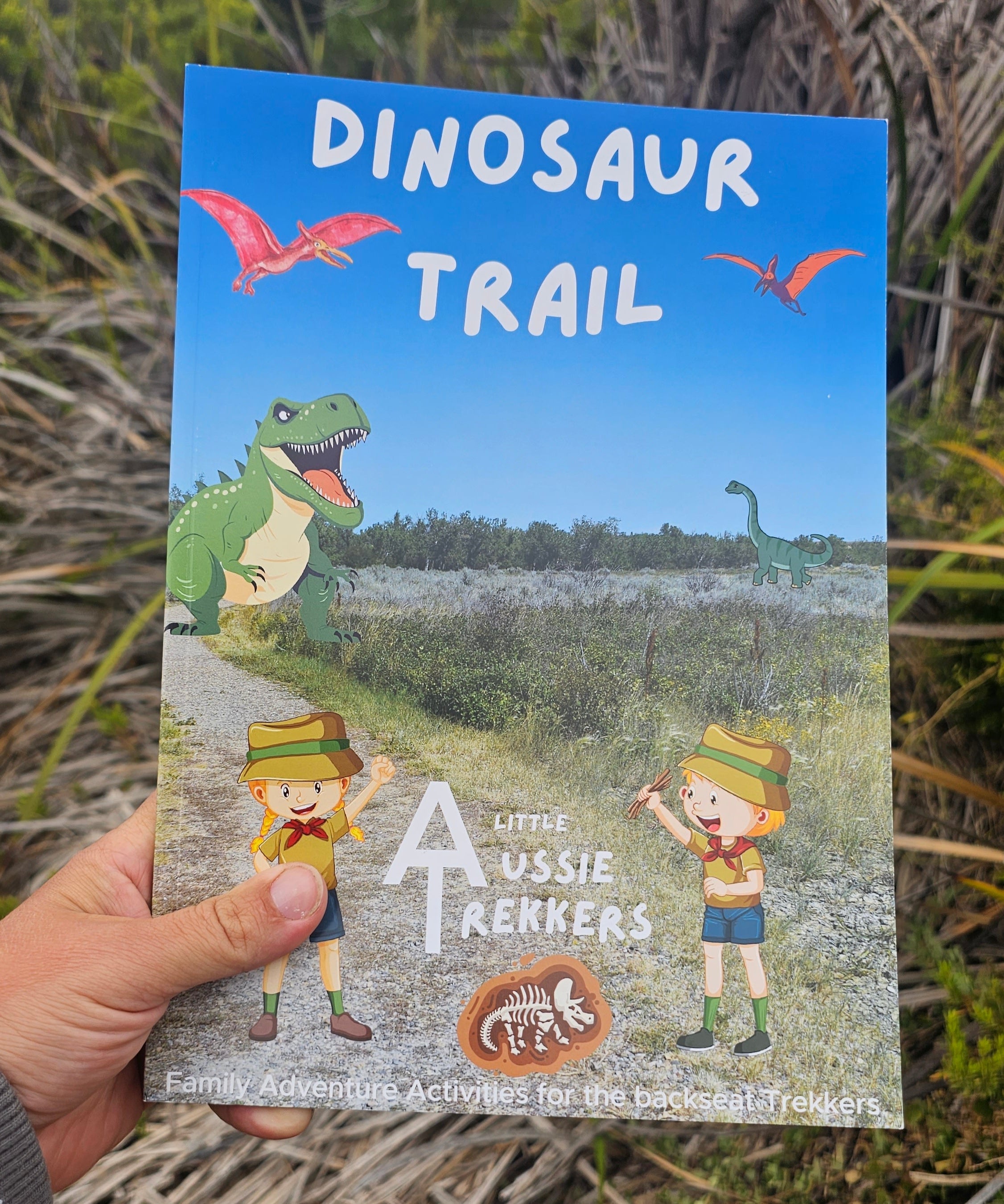 Dinsosaur travel journal held up