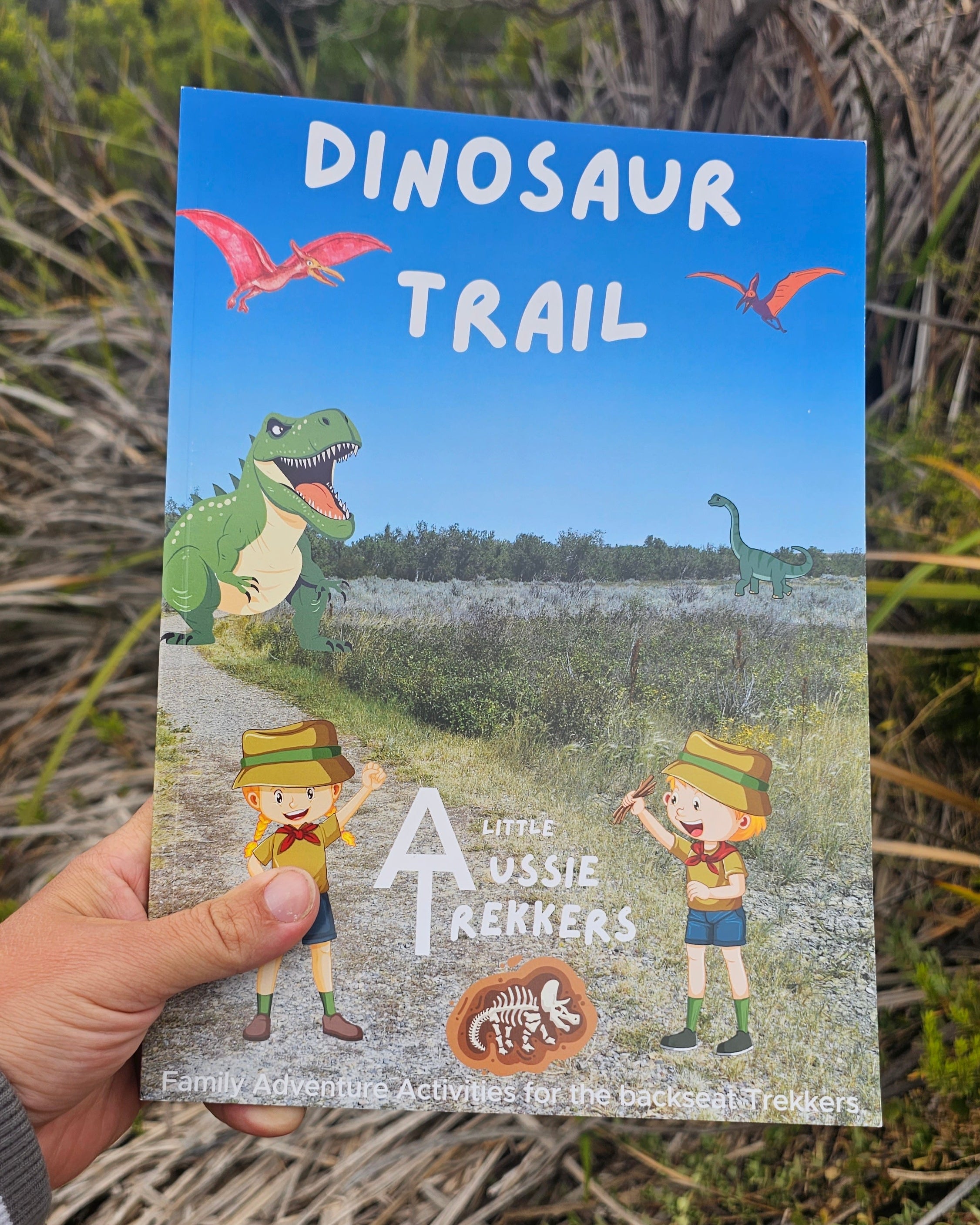 Dinsosaur travel journal held up