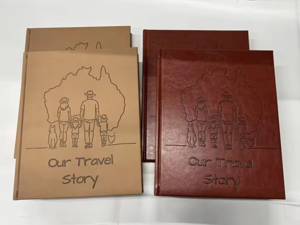 Two leather-bound Australian Travel Journals titled 'Our Travel Story' with a family and dog illustration debossed into journal