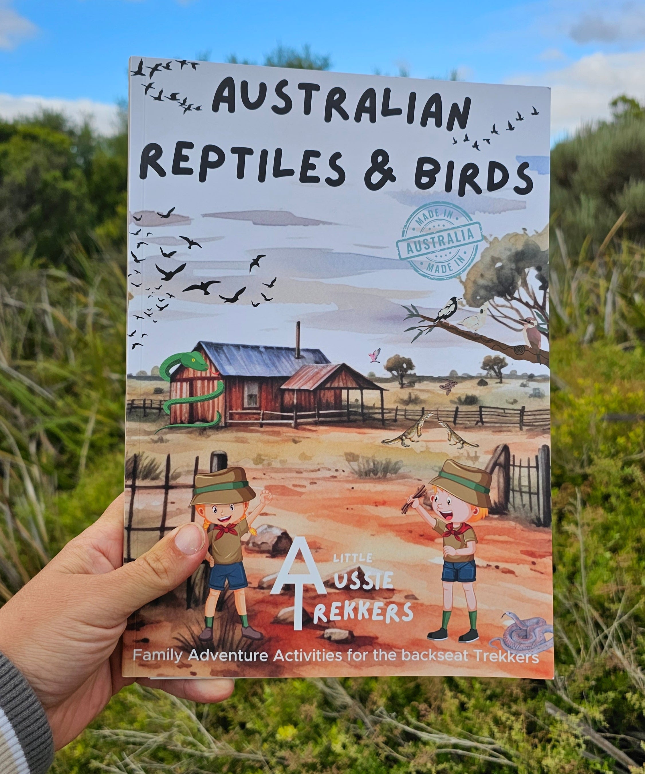 Australian reptiles and birds activity book held up