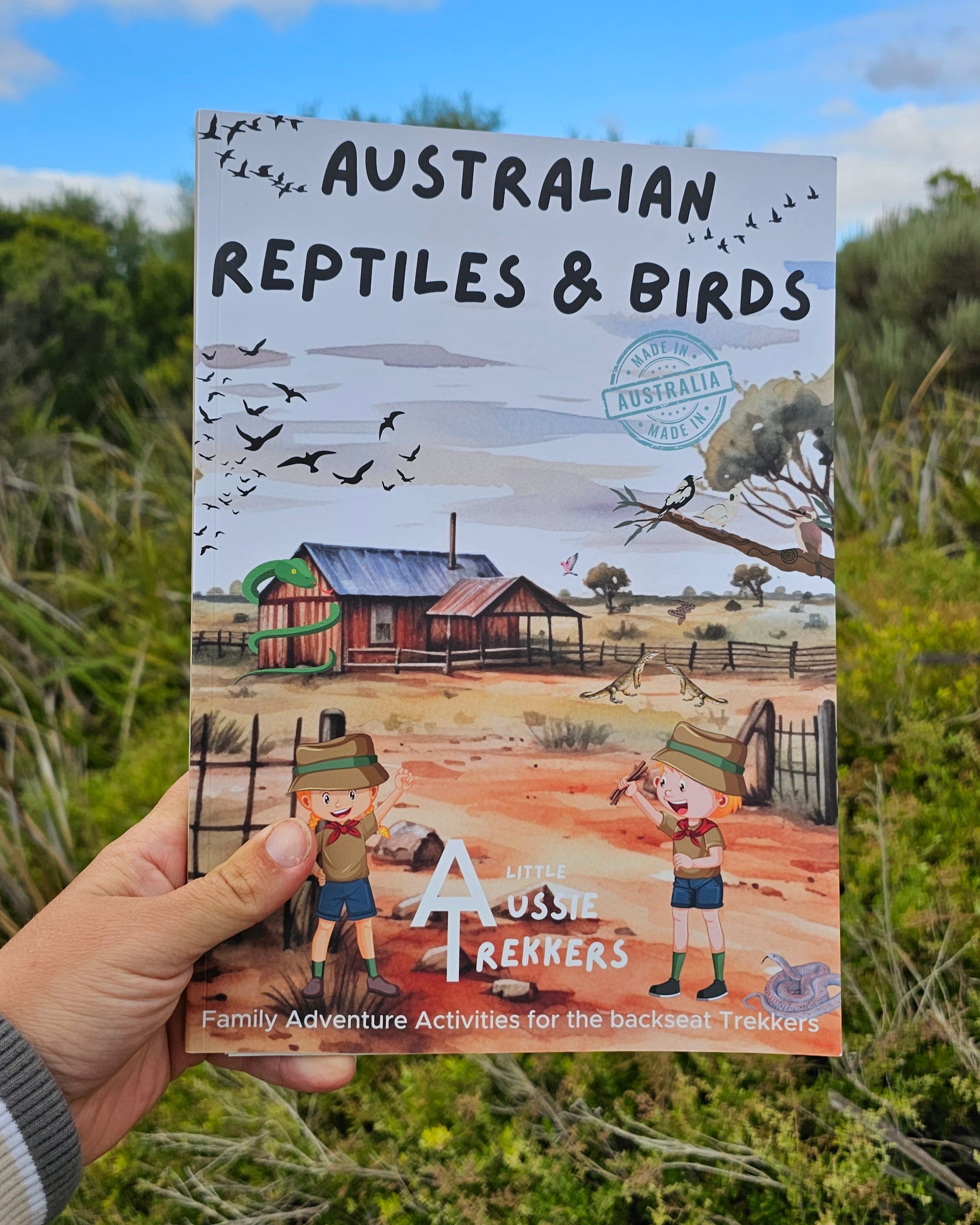 Australian reptiles and birds activity book held up
