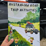 Australian Road Trip Activitys book held up in front of car