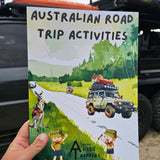 Australian Road Trip Activitys book held up in front of car